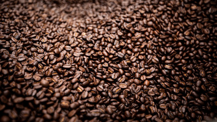raw coffee beans covered surface close up background and texture detail