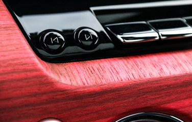 Plakat Modern luxury car white interior with natural wood panel. Part of lcar dashboard. Interior of prestige modern car. Media control buttons. Car detailing. Car inside. Close up