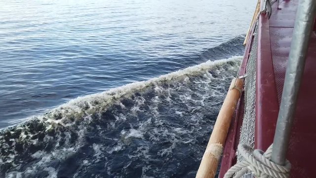 Side of the ship with bow wave. 