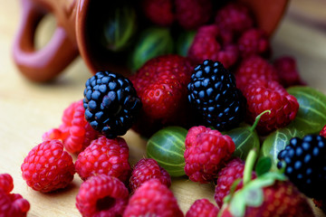 Different berries on a wooden background