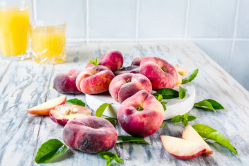 Ripe and Juicy peaches on table with fresh juice in background