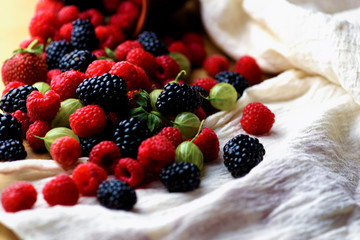 Different berries on a wooden background