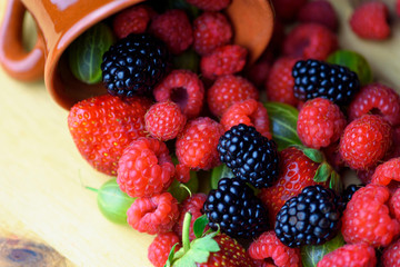 Different berries on a wooden background