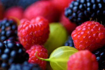 Different berries on a wooden background