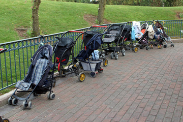 Fototapeta na wymiar Empty children carriages at autumn park