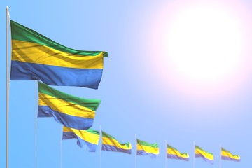 beautiful many Gabon flags placed diagonal with bokeh and empty space for your text - any feast flag 3d illustration..