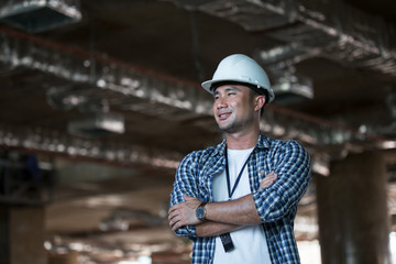 Handsome construction engineer smiling on site construction