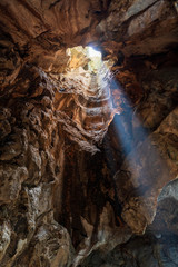 Interior of a rocky cave illuminated by sunlight