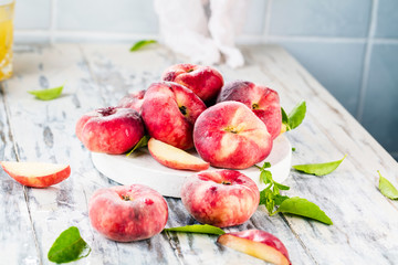 Ripe and Juicy peaches on table with fresh juice in background