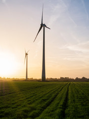 Obraz premium Windmill energy turbine at sunset