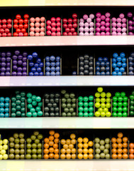 Many colored pencils on the counter in the store for drawing painting . Accessories, chancery, drawing. Colorful background.
