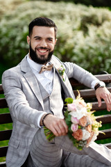 Man Clothed Stylish Suit Holding Bouquet of Flower