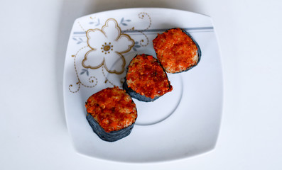 Spicy tuna sushi roll on white background.