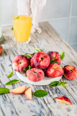 Ripe and Juicy peaches on table with fresh juice in background