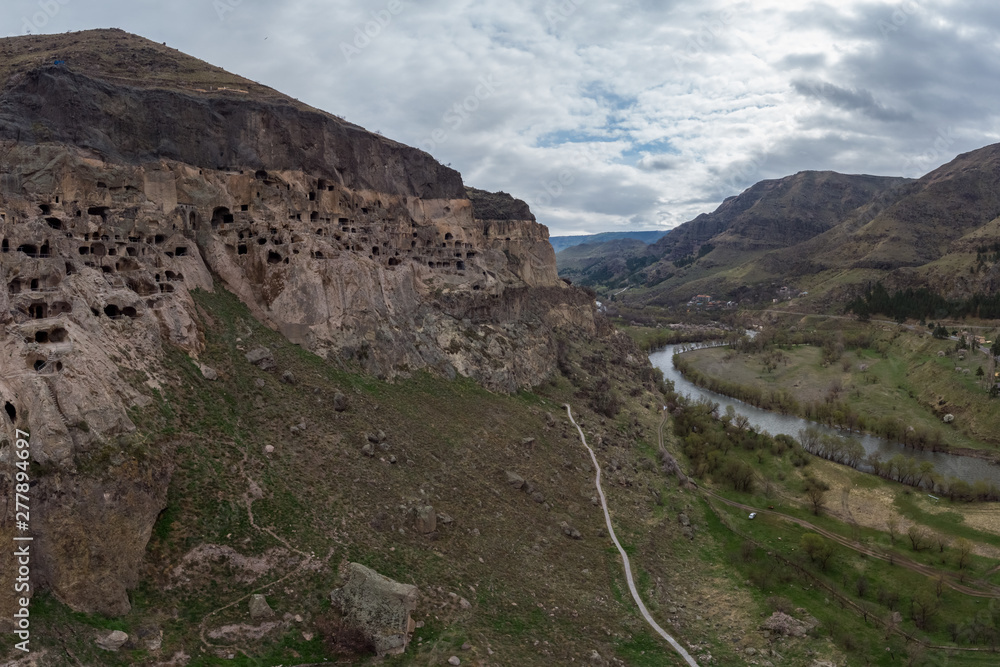 Wall mural top view of the cave city of vardzia on the banks of the river kura