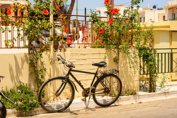 Fototapeta na wymiar Bicycle is parked close to the wall in Greece