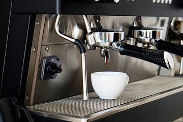 Close up of modern beautiful coffee machine with vintage style black and chrome metal texture design. Macro shot of coffee making equipment. Copy space, background.