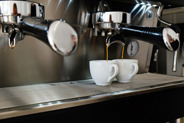 Close up of modern beautiful coffee machine with vintage style black and chrome metal texture design. Macro shot of coffee making equipment. Copy space, background.