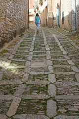 Tourist walking through the medieval lanes of Erice (Sicily, Italy)