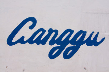 Blue Canggu text drawn on a white wall