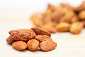 Almonds on wood background texture.