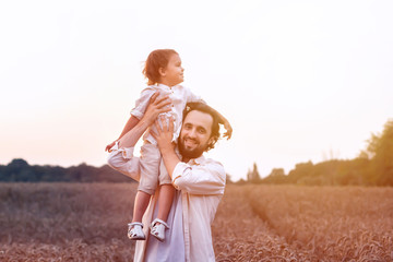 Fototapeta premium father's day. Dad and son playing together outdoors on a summer. Happy family, father, son at sunset. The concept of organic farming and healthy lifestyle, happiness and joy