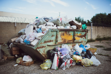 big garbage bin littered with waste.Bin, trash bag plastic waste, Garbage bag pile, Pollution from...