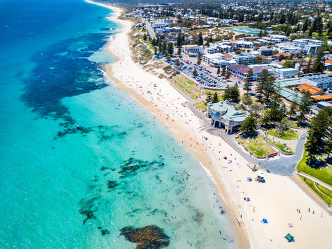 Aerial drone photo of a busy Cottesloe Beach, Perth, Western Australia on a summer afternoon.