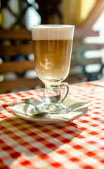 A Cup of coffee latte is on the table in the cafe 