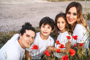 Portrait of a young family smiling and happy looking at the camera on the outside