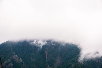 mountain peaks in misty clouds