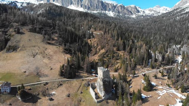 An old castle Castello di Andraz surrounded by forest and mountains - Dolomites, Italy