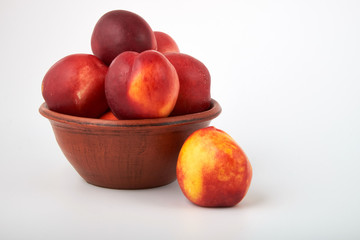 Ripe juicy nectarines isolated on white background