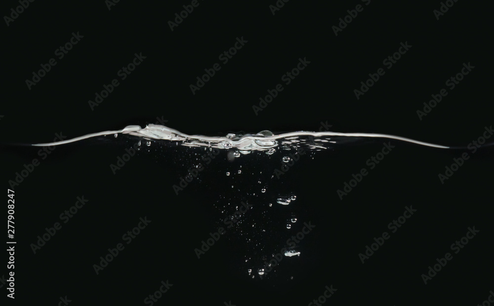 Poster waving water surface and small bubbles underwater isolated on black background, close up view. perfe