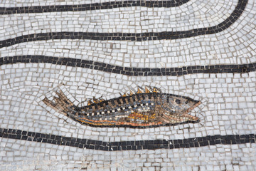black and white mosaic with a colorful fish mosaic in Positano, on the Amalfi coast, Italy