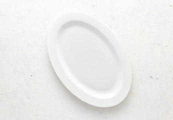 Empty white plate on a white background top view