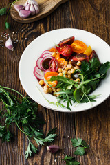 Veggie chickpeas salad with fresh vegetables and herbs, plant based meal
