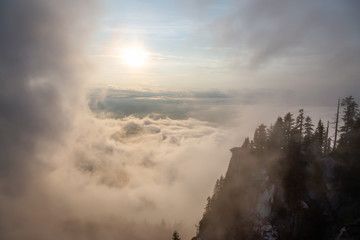 Beautiful View of Canadian Mountain Landscape covered in clouds during a vibrant summer sunset. Taken on top of St Mark's Summit, West Vancouver, British Columbia, Canada.