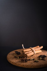 Cinnamon roll with herbs in dark background