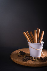 Cinnamon roll with herbs in dark background