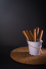 Cinnamon roll with herbs in dark background