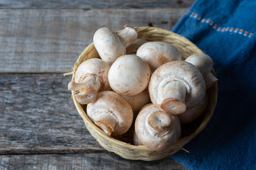 Champignon mushrooms on wooden background
