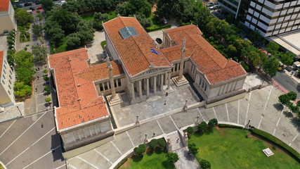 Aerial photo of iconic landmark neoclassic buildings of Academy, University and public Library in the heart of Athens historic centre with beautiful clouds, Attica, Greece