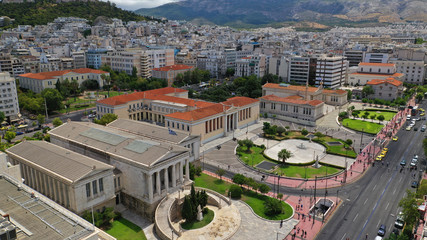 Aerial photo of iconic landmark neoclassic buildings of Academy, University and public Library in the heart of Athens historic centre with beautiful clouds, Attica, Greece