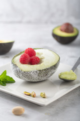 Homemade organic avocado and pistacho ice cream with raspberries