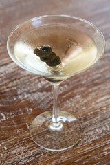 Dry martini in glass on a wooden table