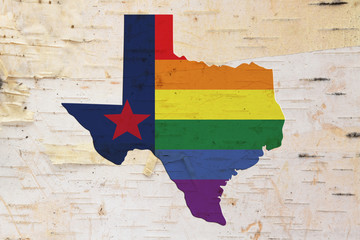A rustic old Texas pride flag with state map on weathered wood