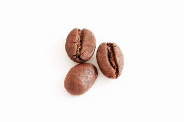 three coffee beans on white background
