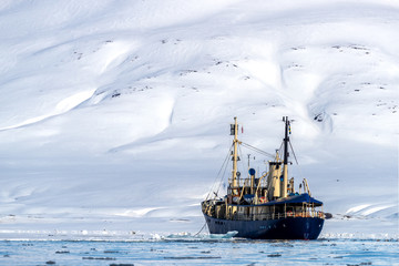 Icebreaker going through the fast ice of Svalbard