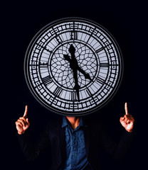 The image of a man wearing a suit with a head is an antique clock. The idea of working with time.